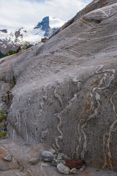 Geologic folding in the glacier-polished rock with Sir Sandford summit in the distance