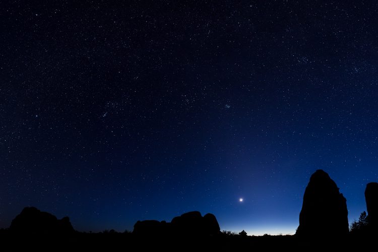 A thin, crescent Moon, with Venus and Mercury just about to set.  Arches National Park.